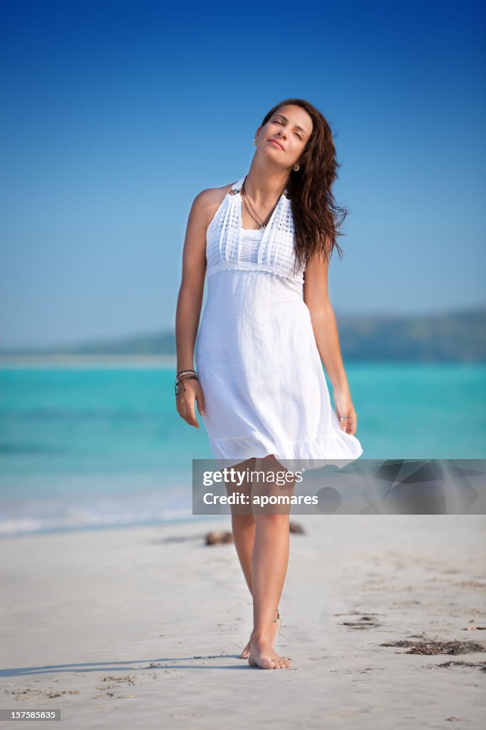 Relaxed young woman walking on a Tropical beach
