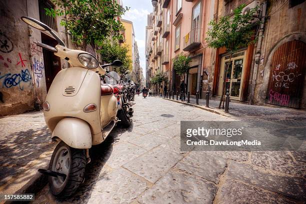 line of vespas on an italian street in the summer - naples italy street stock pictures, royalty-free photos & images