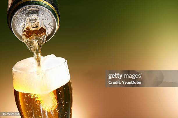 beer being poured from a can into a glass - canister stock pictures, royalty-free photos & images