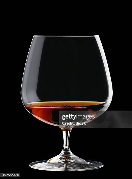a wide glass of brandy isolated on a black background - cognac 個照片及圖片檔