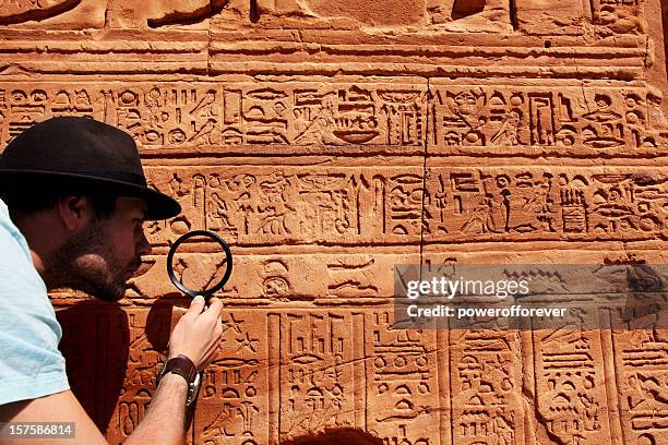 archeologist - hieroglyphics stock-fotos und bilder