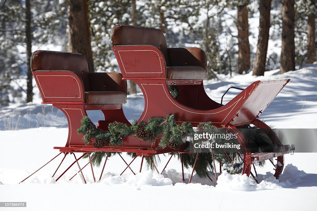 Red Sleigh in Snowy Mountain Woods