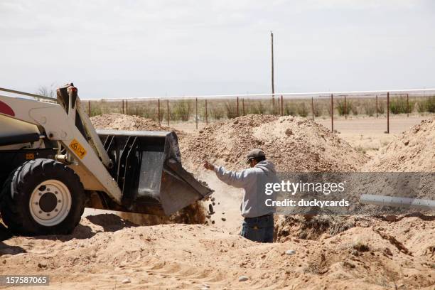 dumping rocks in new drain field for septic system - septic tank stock pictures, royalty-free photos & images