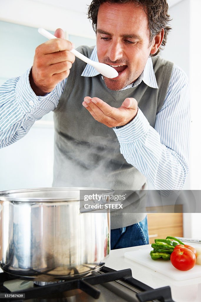 Closeup of a mid adult man tasting food