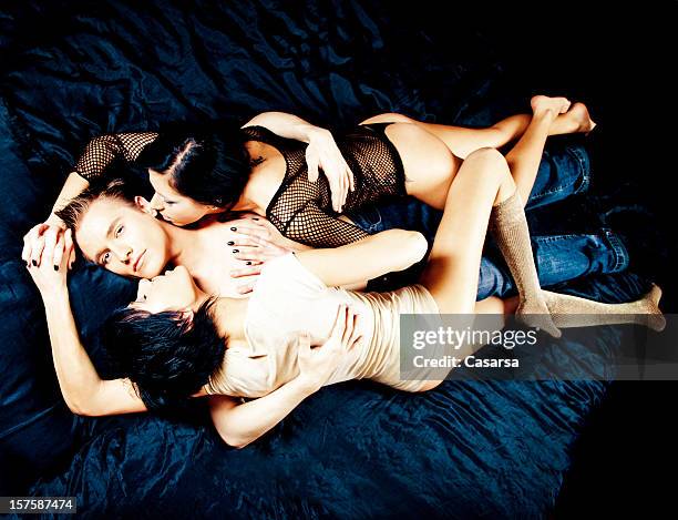 lucky man - three people bed stock pictures, royalty-free photos & images