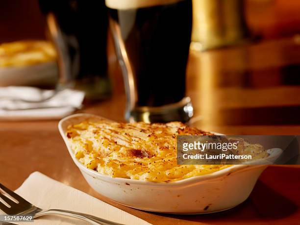 shepherds pie with pints of stout - irish culture stock pictures, royalty-free photos & images