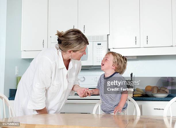 mother trying to calm crying child at home - tantrum stock pictures, royalty-free photos & images