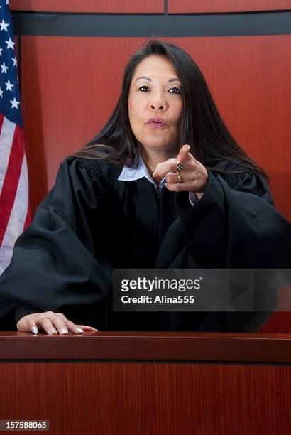 mature female judge pointing a finger at you - serious crimes court stock pictures, royalty-free photos & images