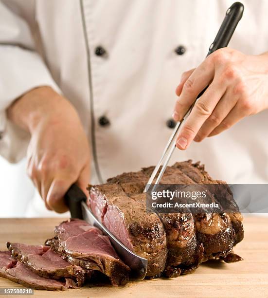 photo of chef carving roast meat  - carving set stock pictures, royalty-free photos & images