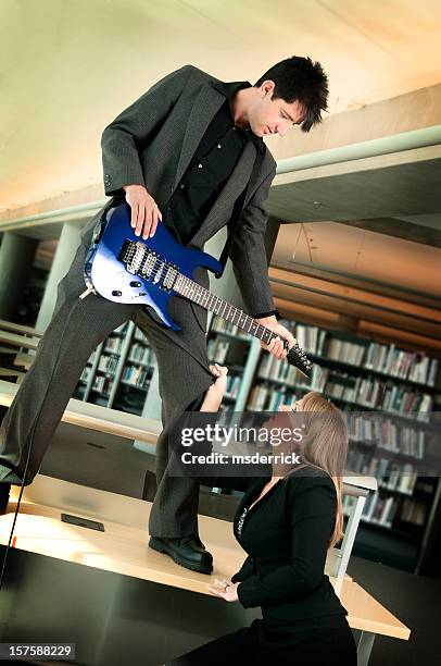 library guitarist and groupie - skill shortage stock pictures, royalty-free photos & images