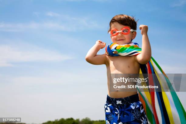 cute boy with swimwear on flexing muscles - simglasögon bildbanksfoton och bilder