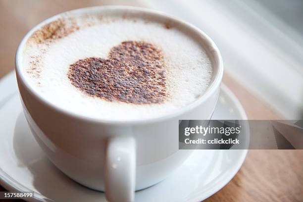 cup of cappuccino with a heart design - coffee heart stock pictures, royalty-free photos & images