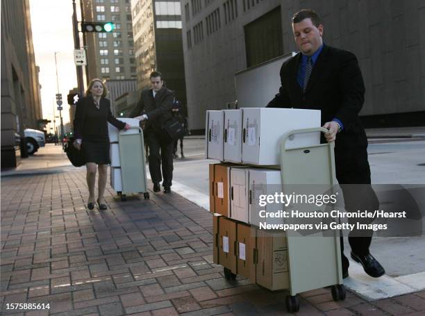 Attorney Daniel Petrocelli's team walk documents to the Bob Casey United States Court House on the fourth day of the Enron trial on Thursday, Feb. 2,...