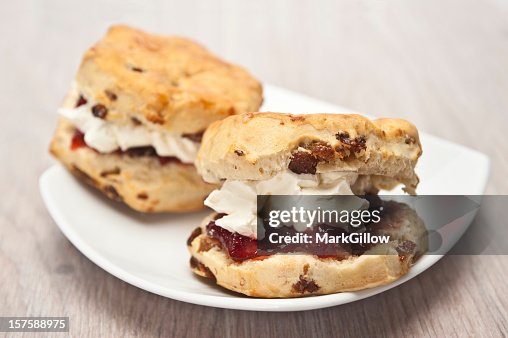 Two scones with jam on a white dish Two scones with jam on a white dish