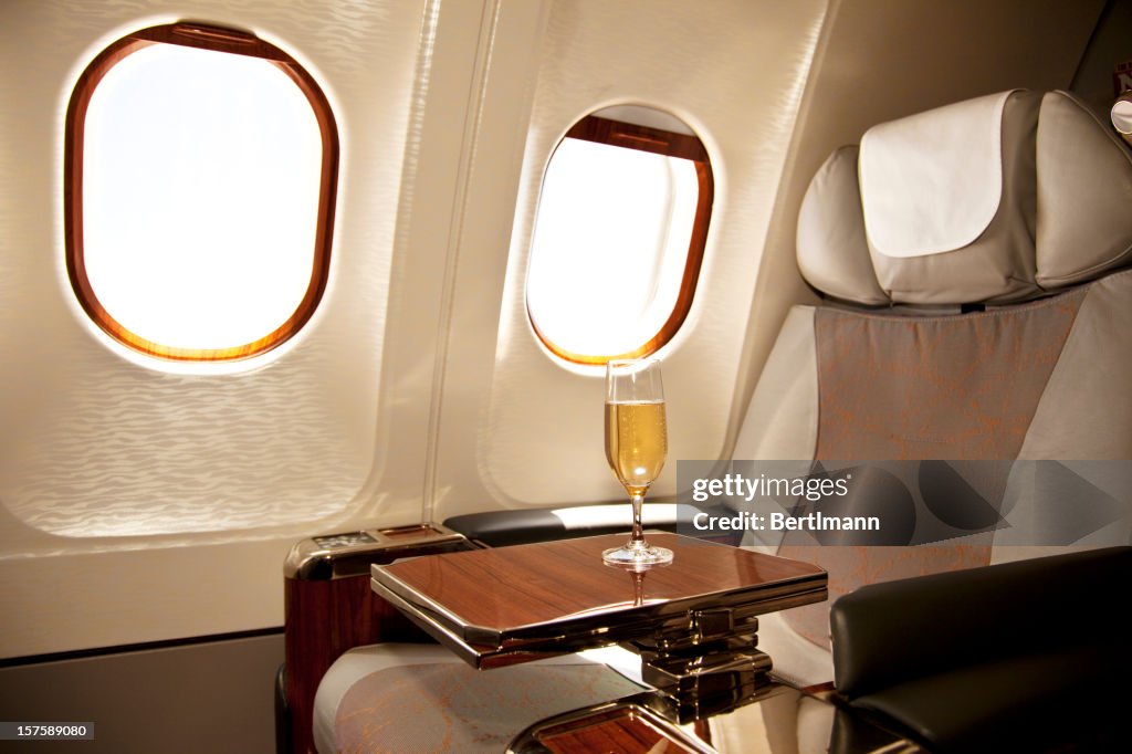 A business class seat on an airplane