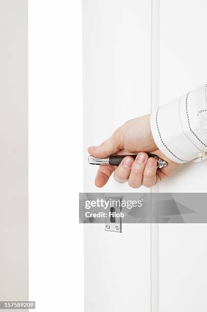 hand opening a door - door handle stock pictures, royalty-free photos & images