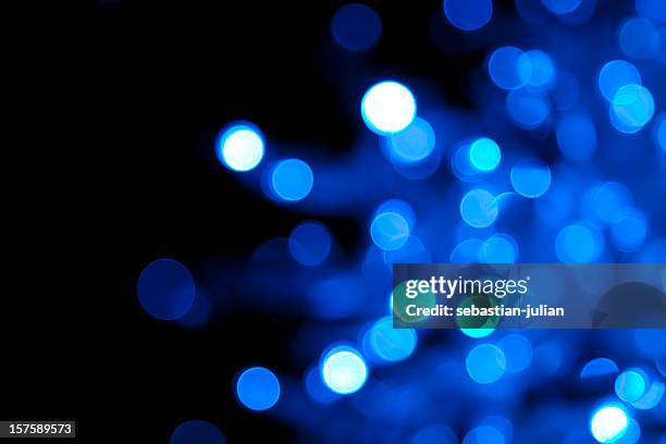 out of focus illuminated blue dots on black background - balls deep stockfoto's en -beelden