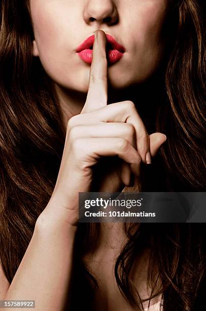 schhhhh - finger on lips stock-fotos und bilder