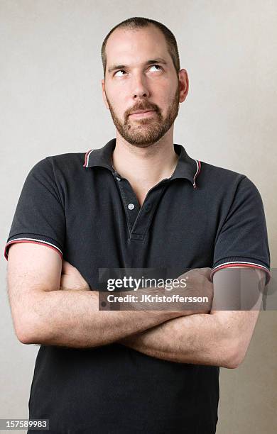 man with crossed arms rolls his eyes - eye roll stock pictures, royalty-free photos & images