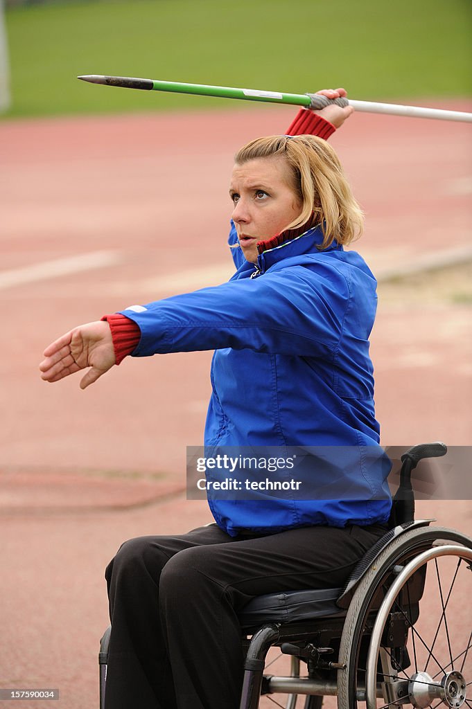 Paraplegic on wheelchair exercising javelin