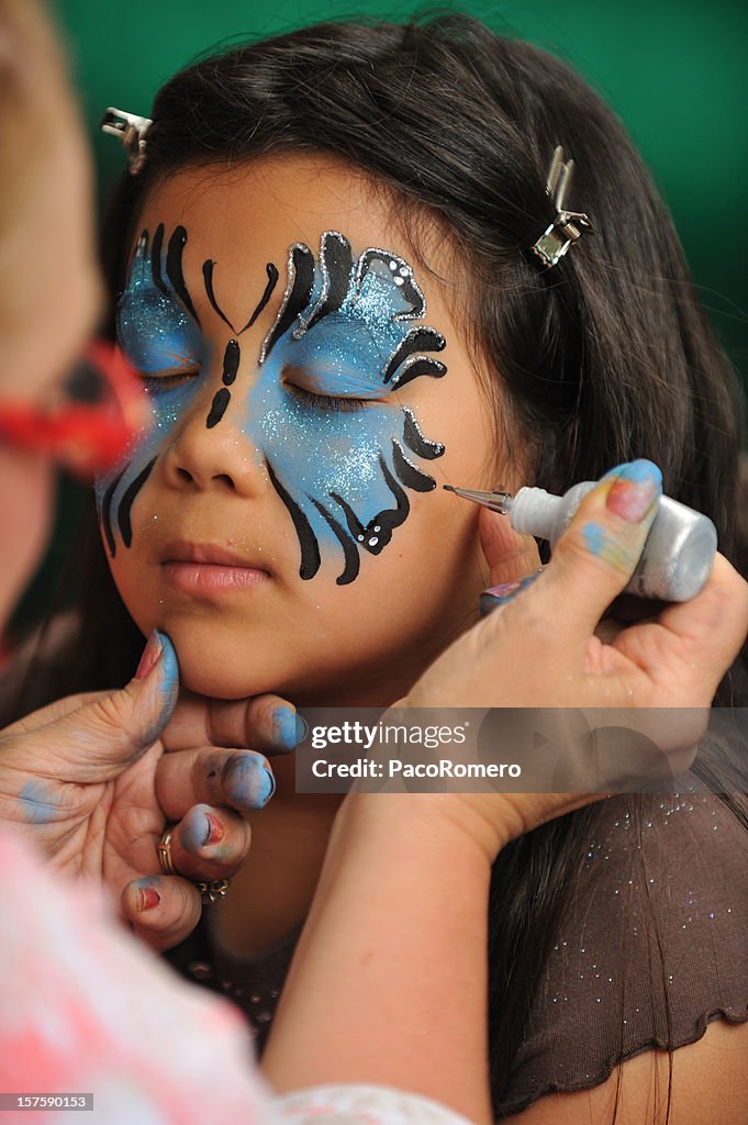 Girl getting her face painted