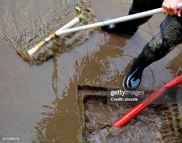 storm sewer flood dirty water cleanup - dirty rain boot stock pictures, royalty-free photos & images