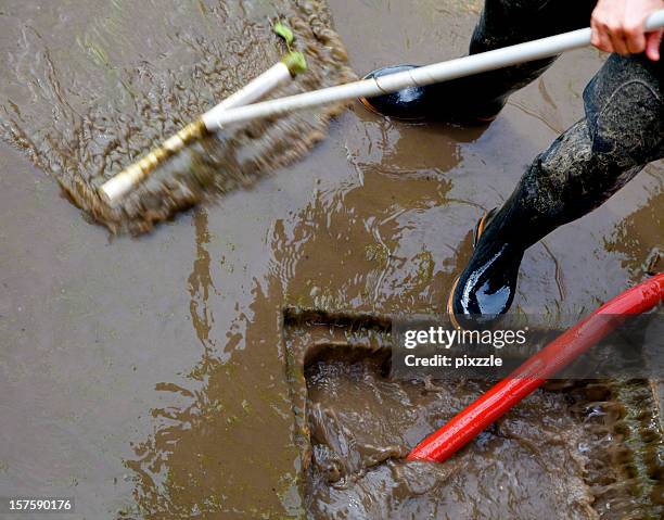 storm sewer flood dirty water cleanup - wellington boots stock pictures, royalty-free photos & images