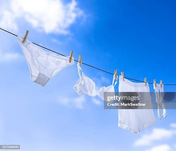 prices of white underwear hanging in clear blue sky - washing line stock pictures, royalty-free photos & images