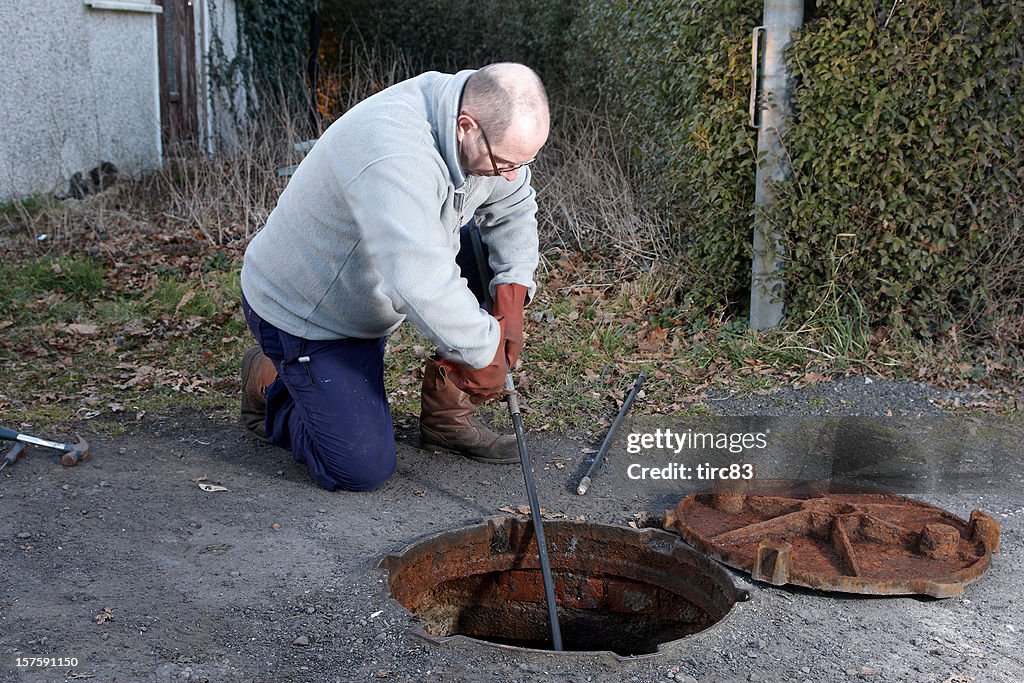 Man clearing the drains