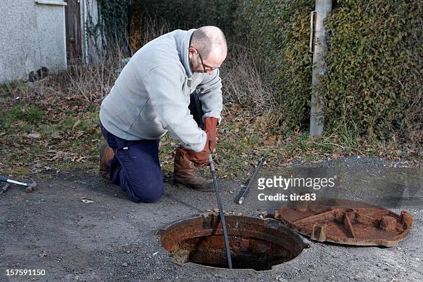 man clearing the drains - septic tank stock pictures, royalty-free photos & images