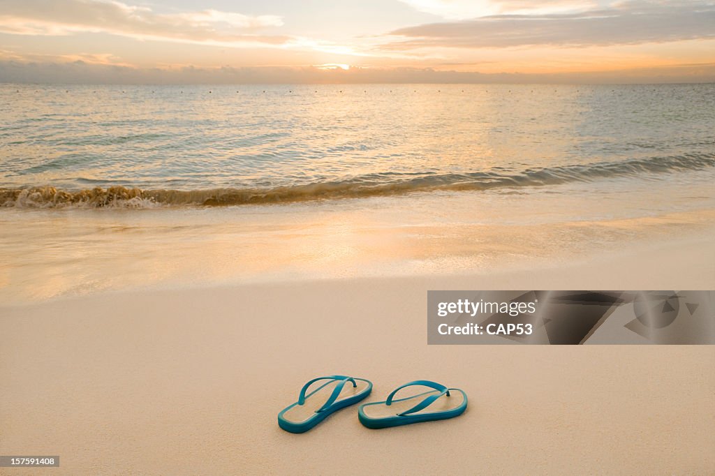 Sandalias en la playa con un buen Sunrise