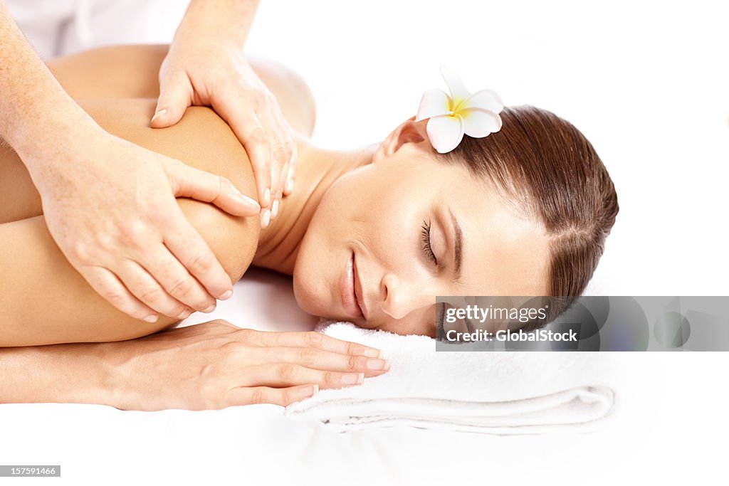 Young relaxed woman enjoying a back massage at the dayspa