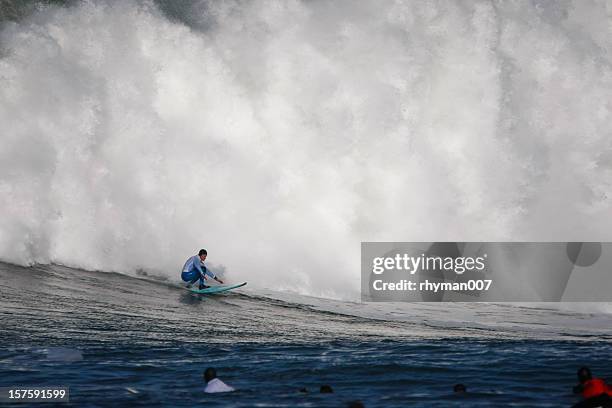 surfing a huge wave - big wave surfing stock pictures, royalty-free photos & images