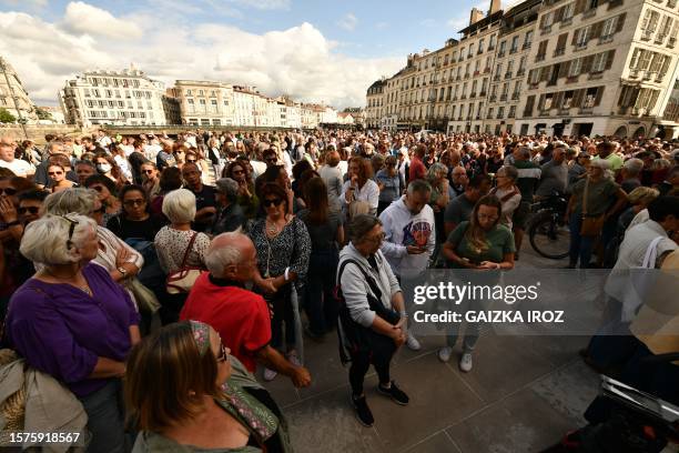 People gather in tribute to a 46-year-old man attacked during the Bayonne Fetes, in front of Bayonne's townhall, southwestern France, on August 4,...