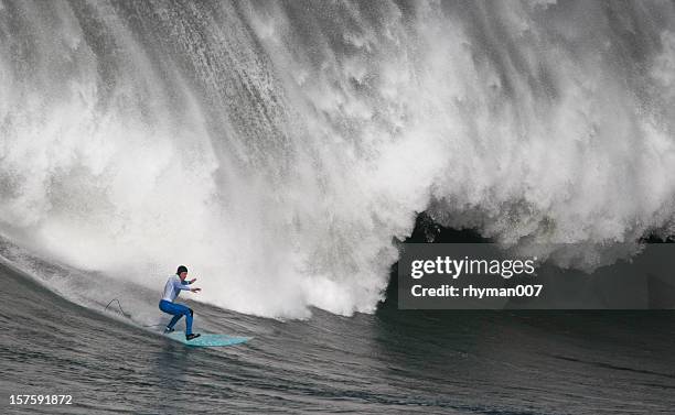 surfing the curl of a huge wave - big wave surfing stock pictures, royalty-free photos & images