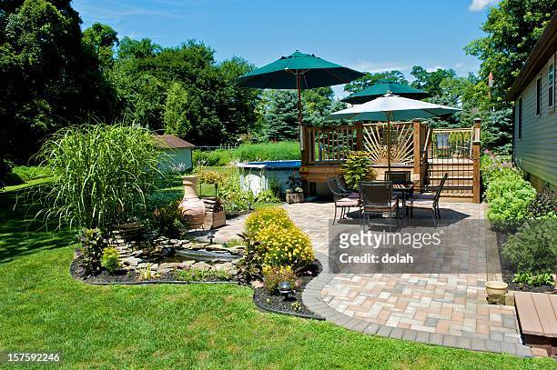 sunny day on a terrace with table and sun umbrella - landscaped stock pictures, royalty-free photos & images