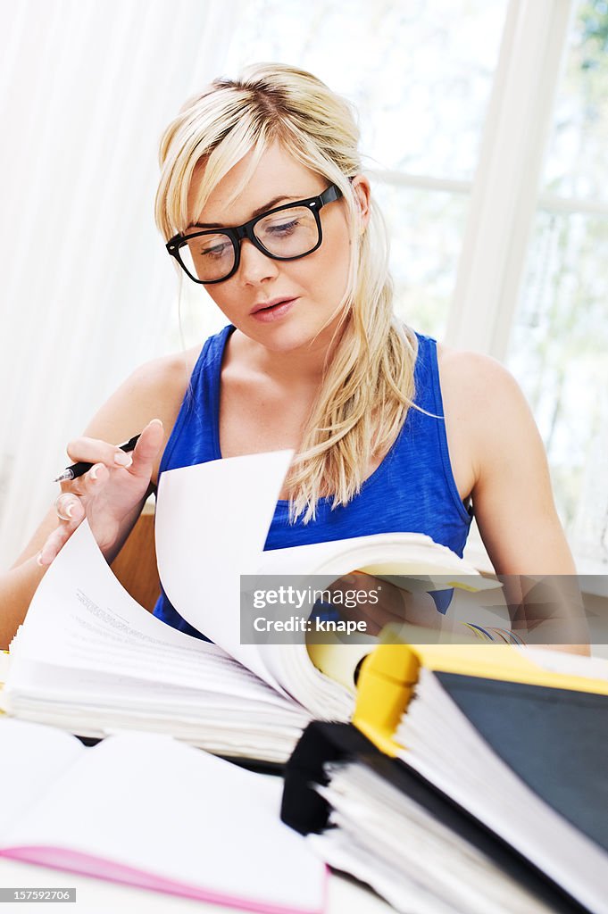 Woman occupied with paperwork