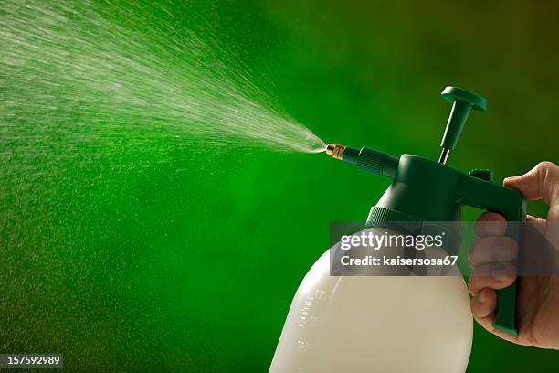 man spraying with a garden bottle - herbicide spraying stock pictures, royalty-free photos & images