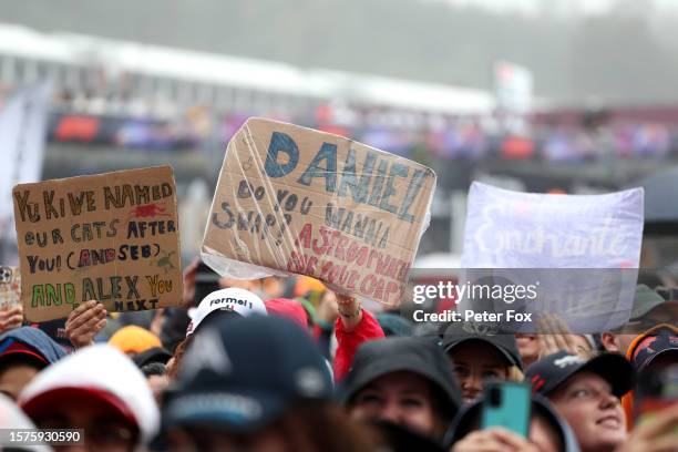 Daniel Ricciardo of Australia and Scuderia AlphaTauri fans hold signs at the fan stage to show their support during practice ahead of the F1 Grand...