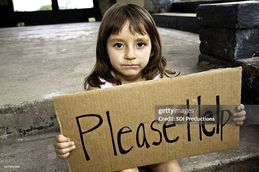 Young Hispanic Girl Holding a Please Help Sign