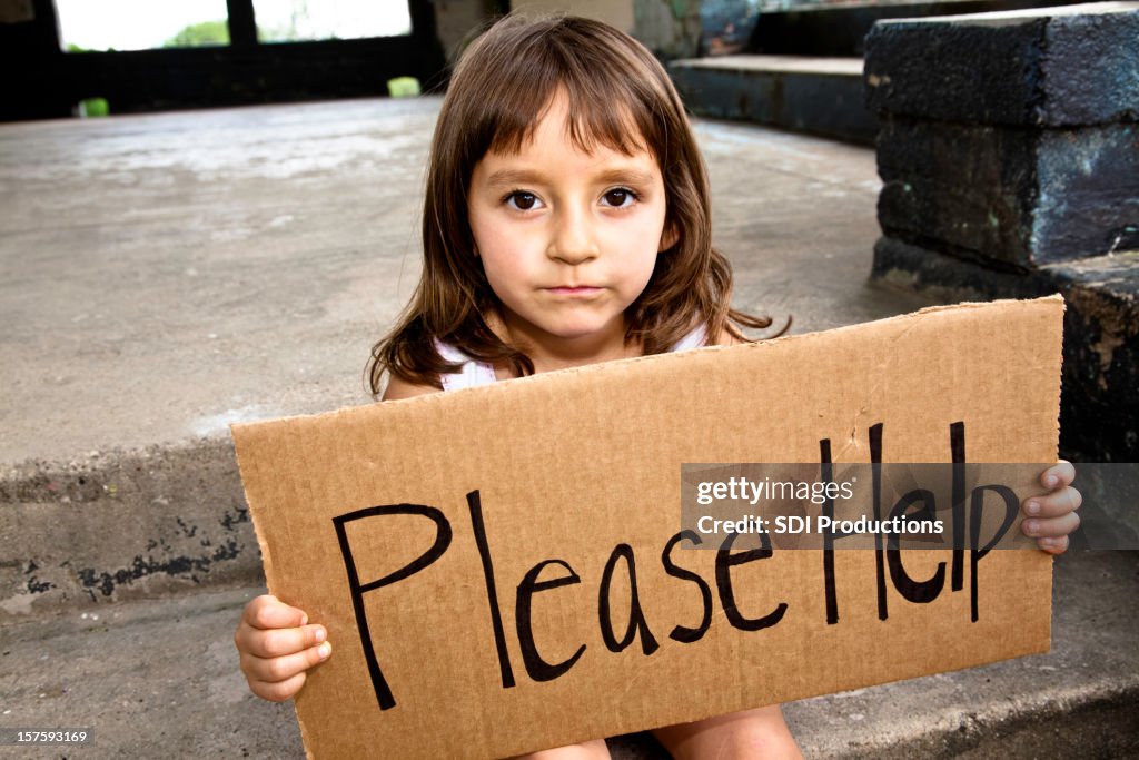 Young Hispanic Girl Holding a Please Help Sign