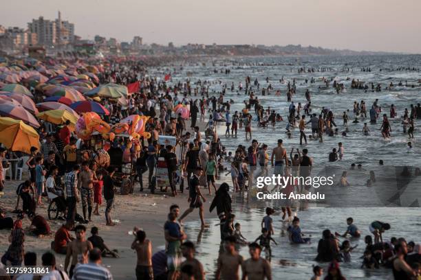 Palestinian people swim to cool themselves off during the hot weather in Gaza City, Gaza on August 04, 2023.