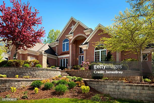 mansion home exterior design; terraced paved landscape, colorful spring foliage - landscaped stock pictures, royalty-free photos & images