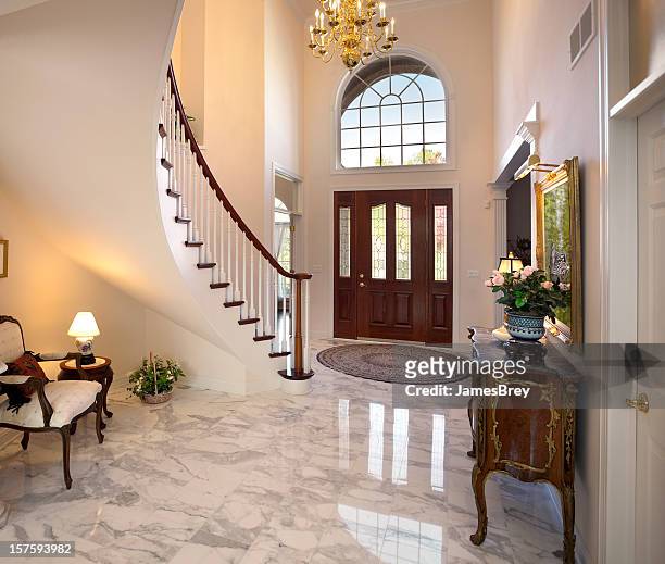 grand foyer; staircase, chandelier, marble floor showcase home interior design - luxury mansion interior stock pictures, royalty-free photos & images