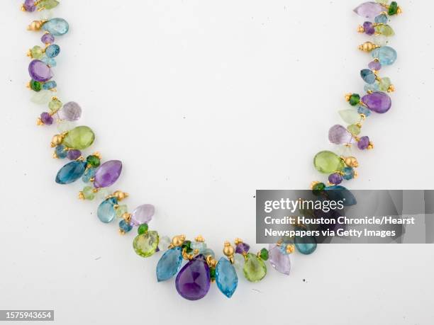 Amethyst, blue topaz, peridot, prehnite, zircon, green quartz and chrome diopside, 22k yellow gold, $3720 at I.W. Marks jewelry photographed for the...