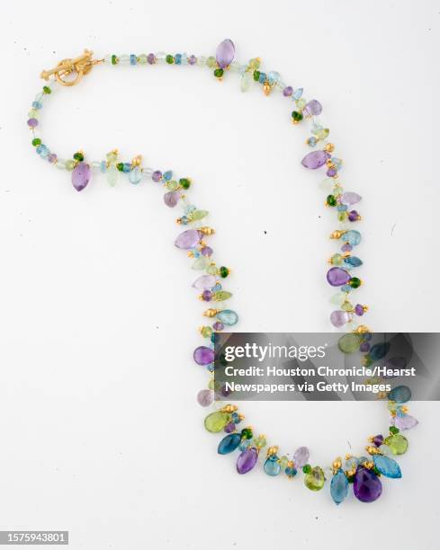 Amethyst, blue topaz, peridot, prehnite, zircon, green quartz and chrome diopside, 22k yellow gold, $3720 at I.W. Marks jewelry photographed for the...
