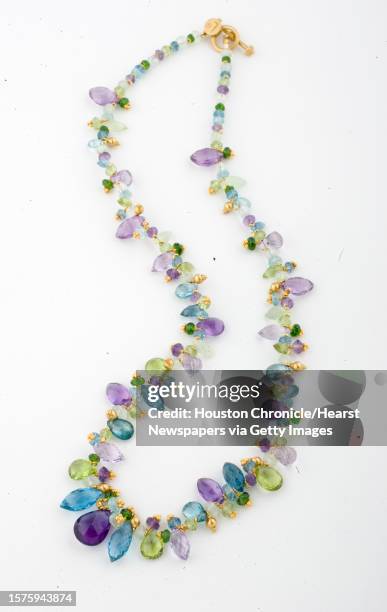 Amethyst, blue topaz, peridot, prehnite, zircon, green quartz and chrome diopside, 22k yellow gold, $3720 at I.W. Marks jewelry photographed for the...