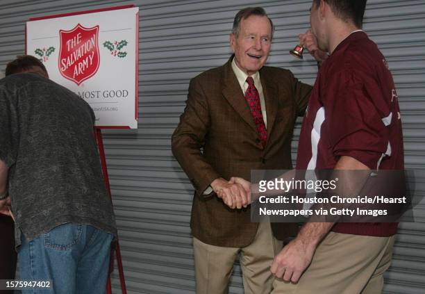 Former president George H.W. Bush rings a bell for the Salvation Army. Bush and former first lady Barbara Bush made an appearance to promote the last...