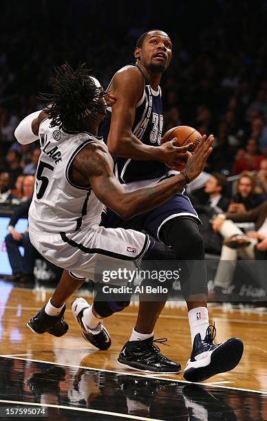 Kevin Durant of the Oklahoma City Thunder drives past Gerald Wallace of the Brooklyn Nets during their game at the Barclays Center on December 4,...