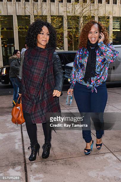 Singers Erica Atkins-Campbell and Trecina Atkins-Campbell, of Mary Mary, enter the Sirius XM Studios on December 4, 2012 in New York City.
